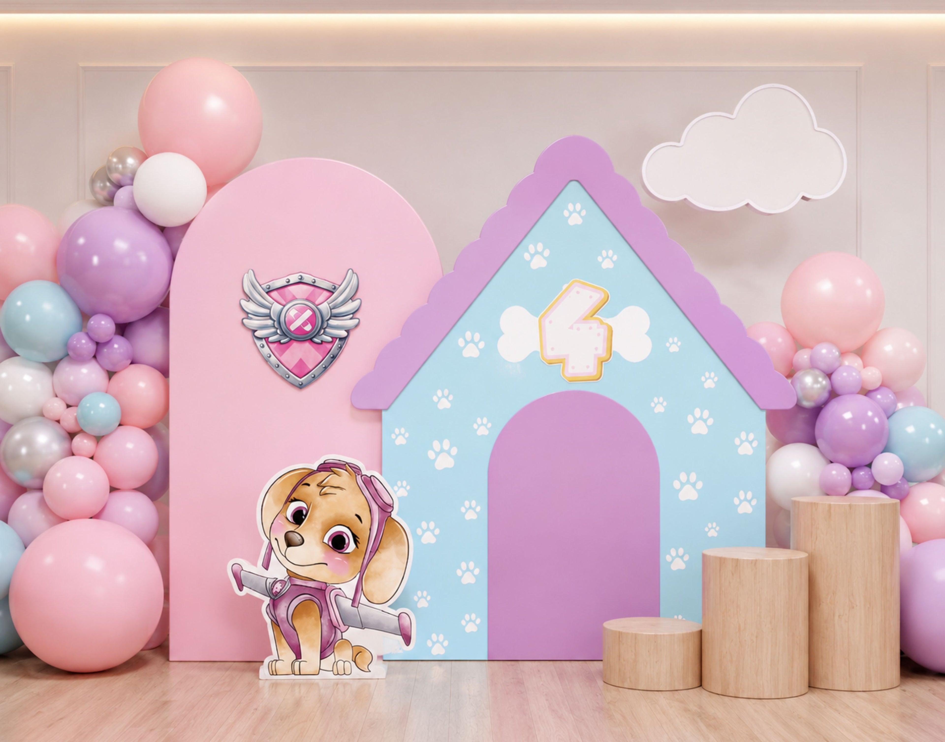 Pink doghouse-style puppy backdrop with balloon clusters, character cutouts and pastel party decor for a girls birthday celebration.