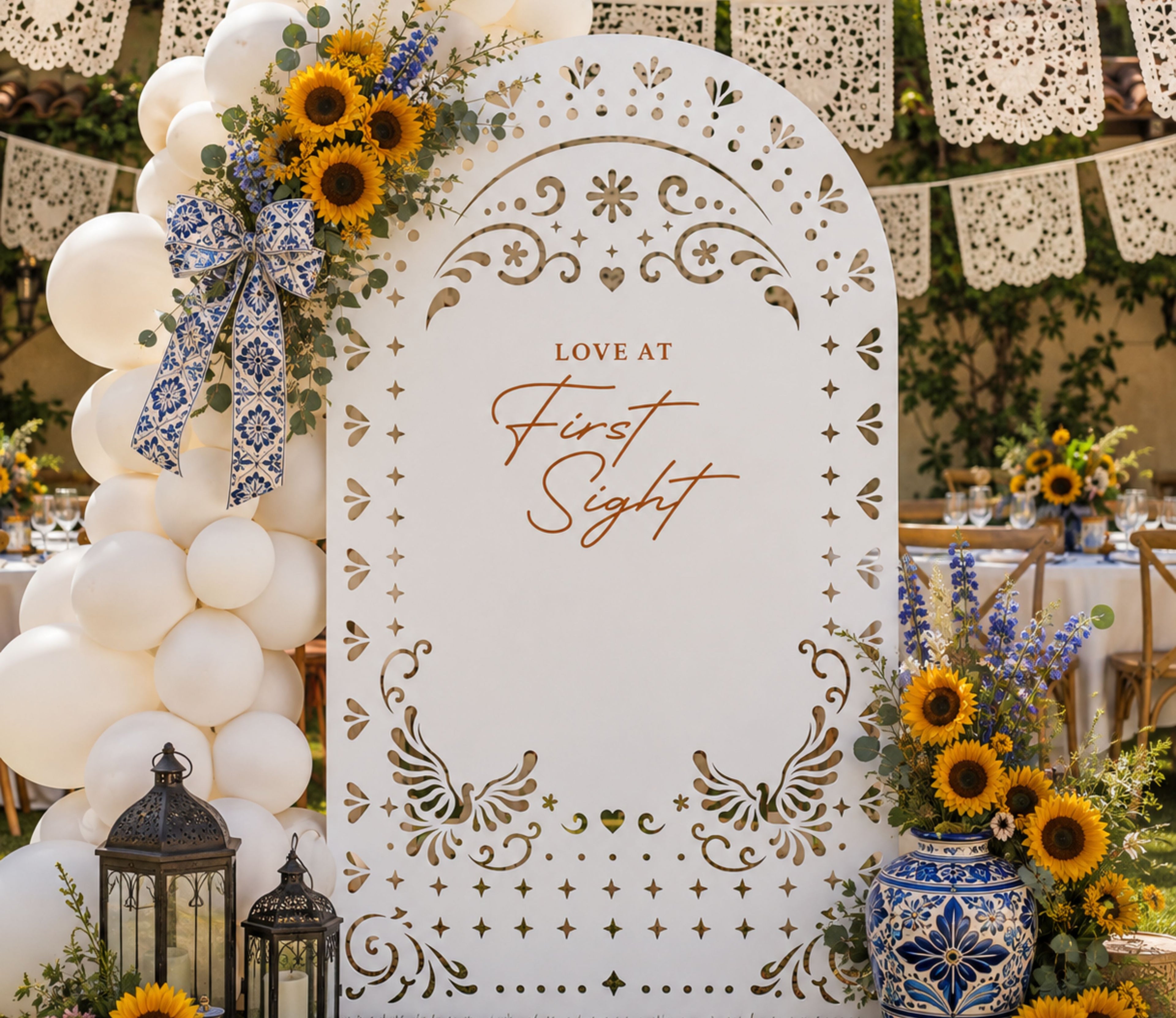 White personalized papel picado wedding backdrop with floral decor for elegant Mexican inspired wedding reception