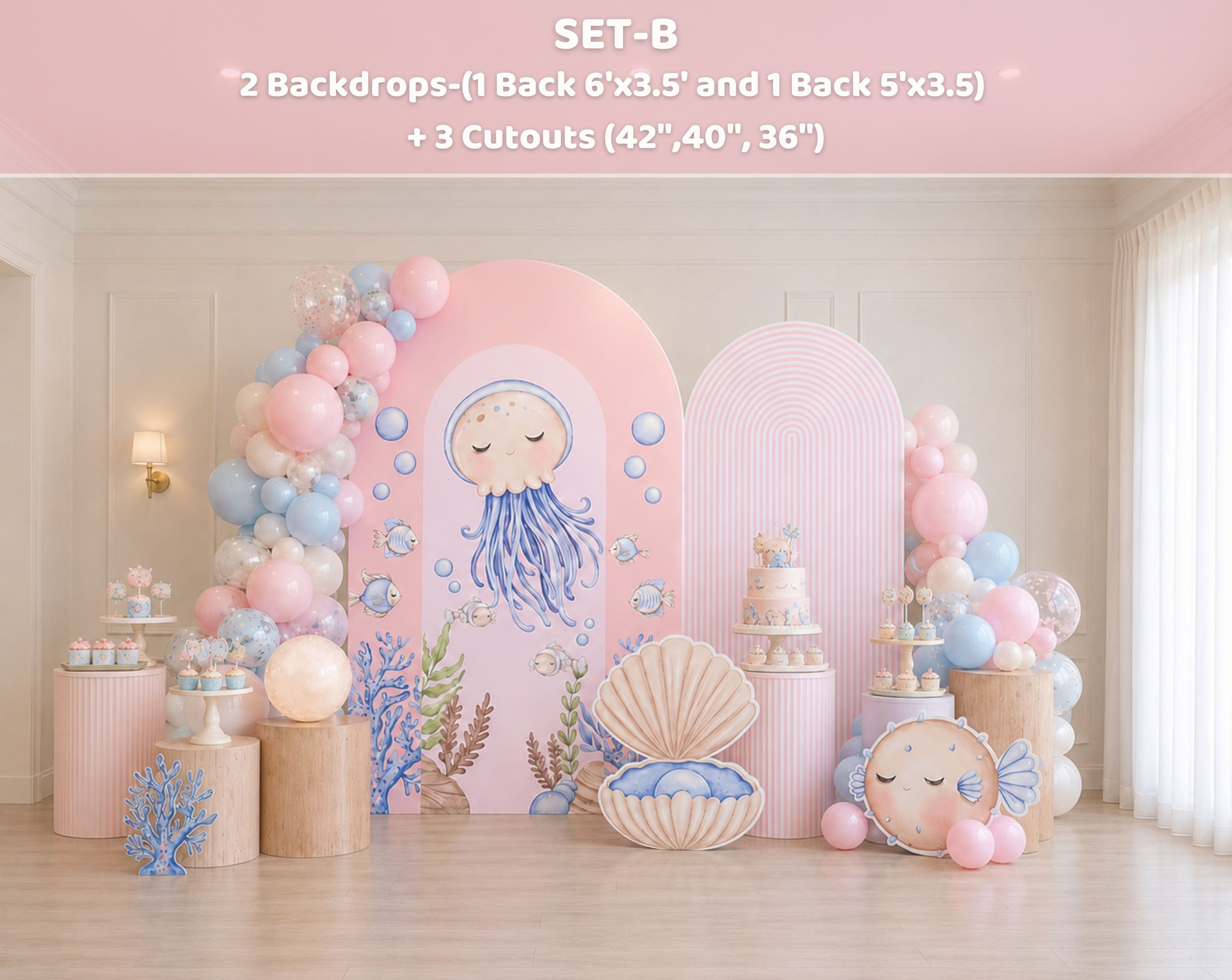 Cute ocean animals party backdrop with pastel pink arch panels, balloon garland and sea themed decorations for a girls birthday party.