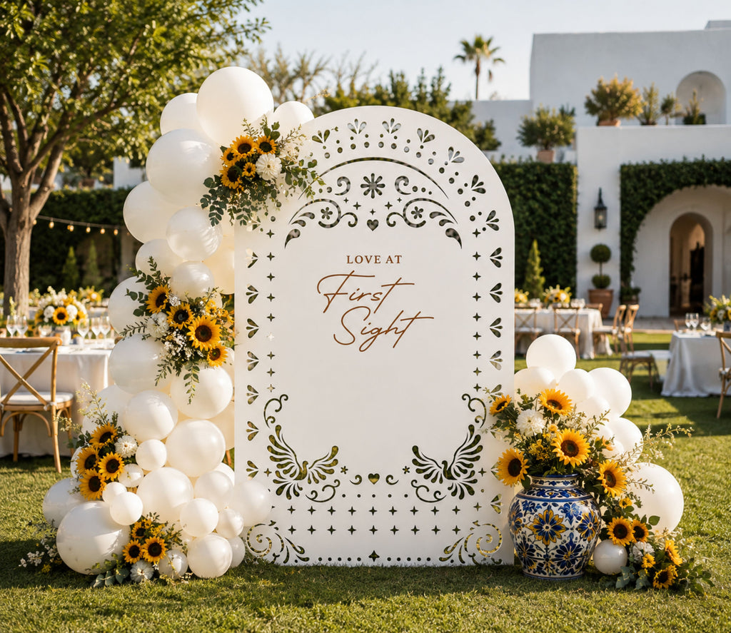 White personalized papel picado wedding backdrop with floral arrangement for elegant outdoor wedding ceremony