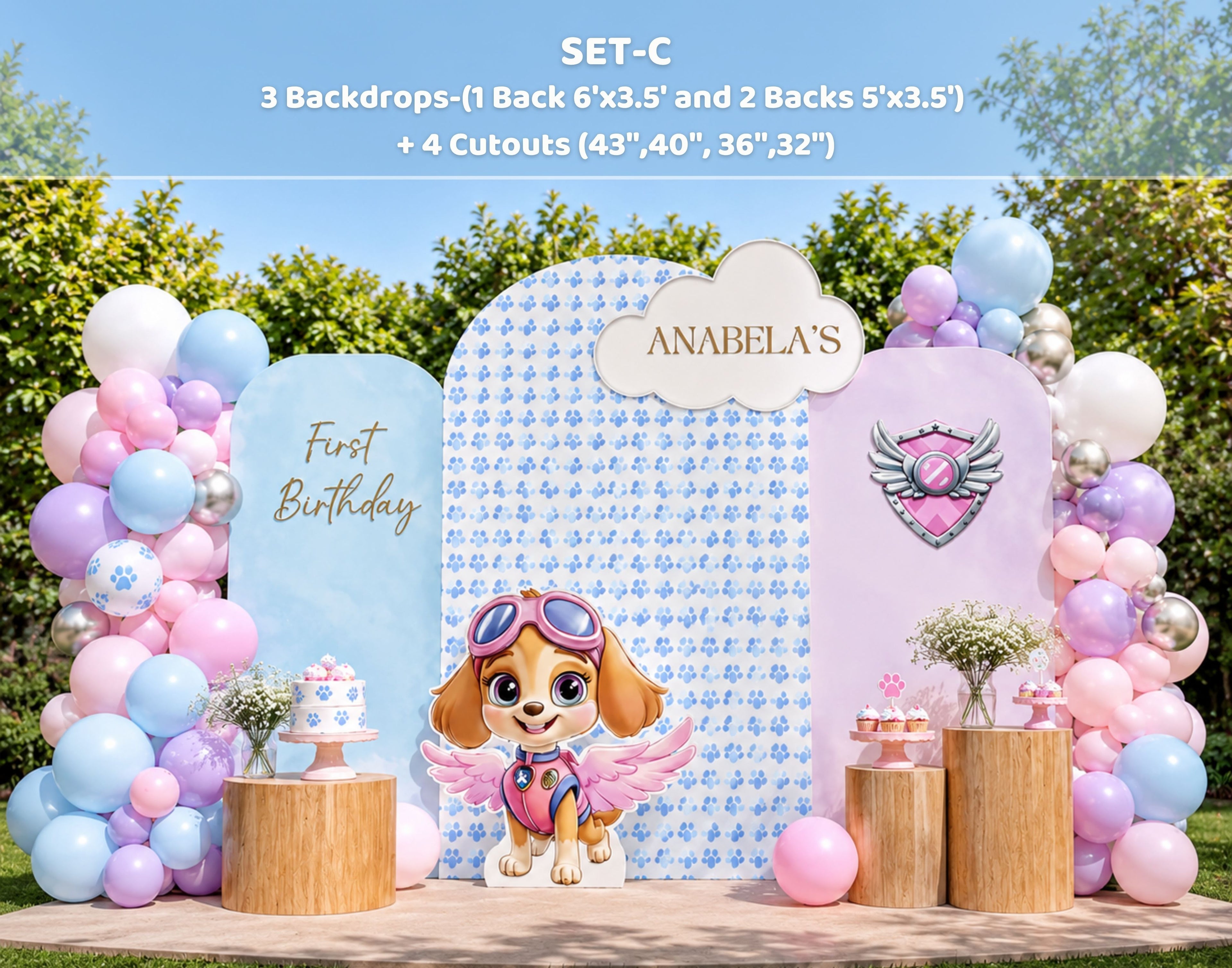 Outdoor pink puppy party backdrop with pastel panels, balloon garland and character cutouts for a playful birthday setup.