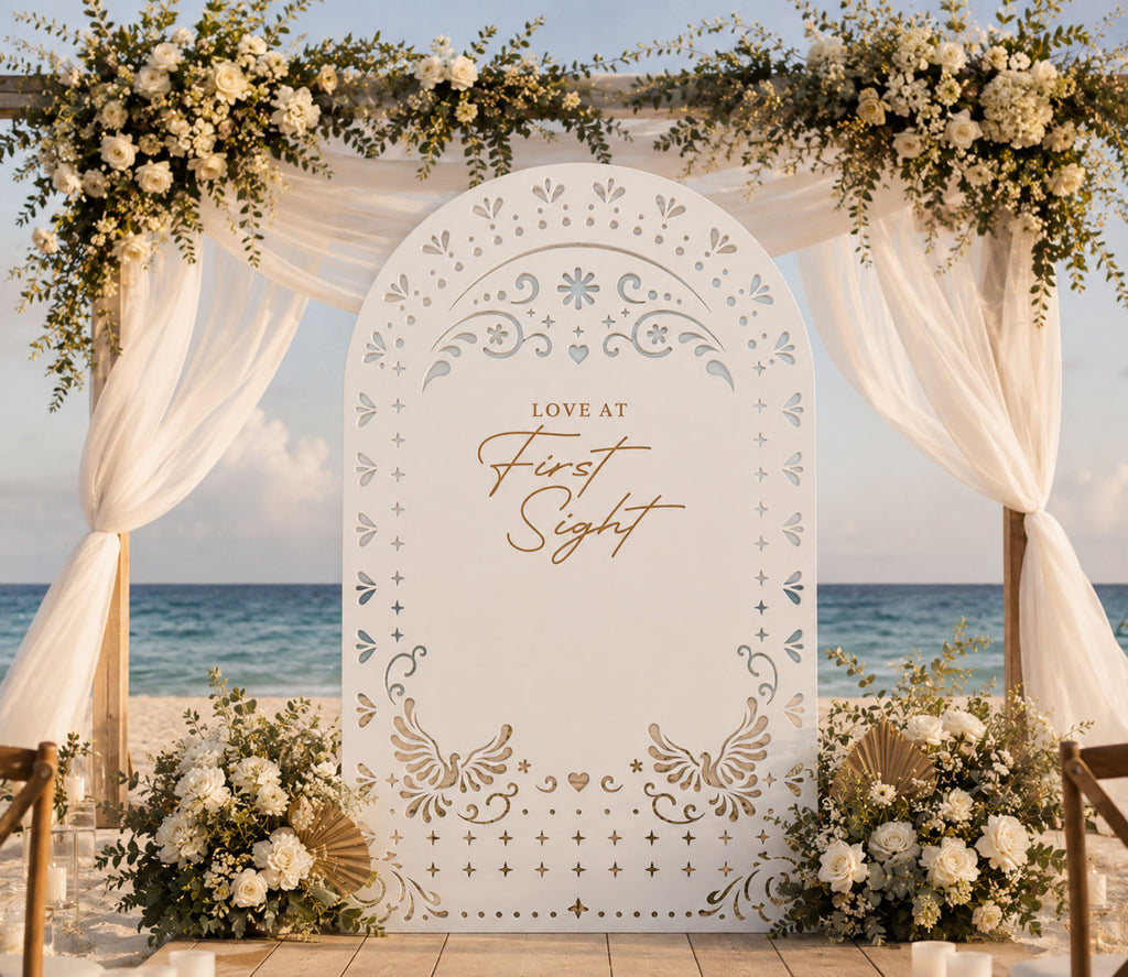Personalized white papel picado wedding backdrop styled with neutral florals for Mexican inspired wedding celebration