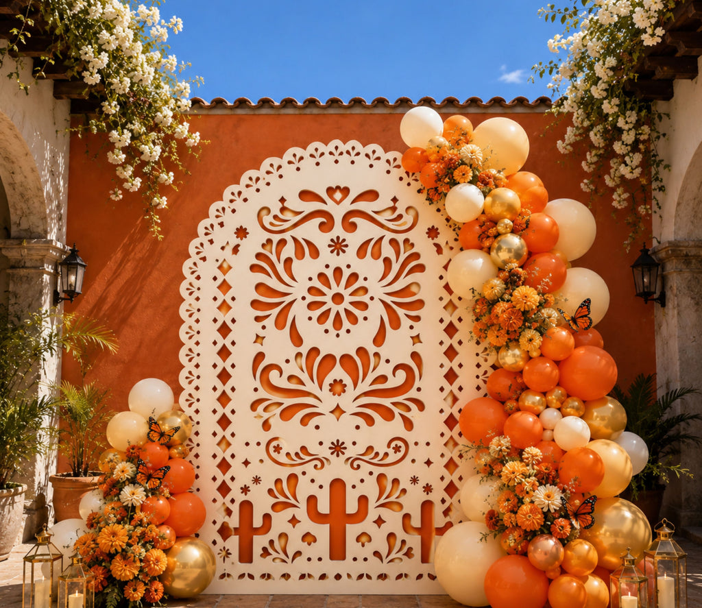 Orange printed papel picado backdrop surrounded by colorful balloons for traditional Mexican party decor