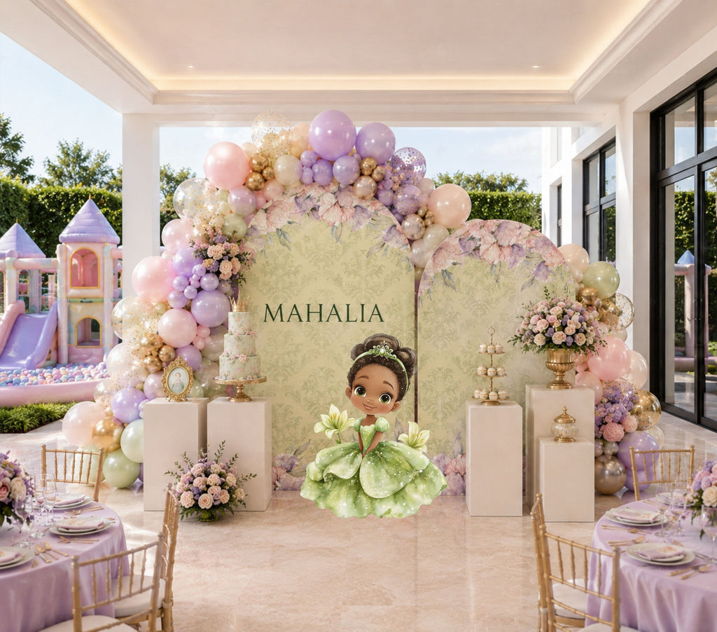 Pastel frog princess backdrop and cutouts styled in an elegant indoor birthday celebration