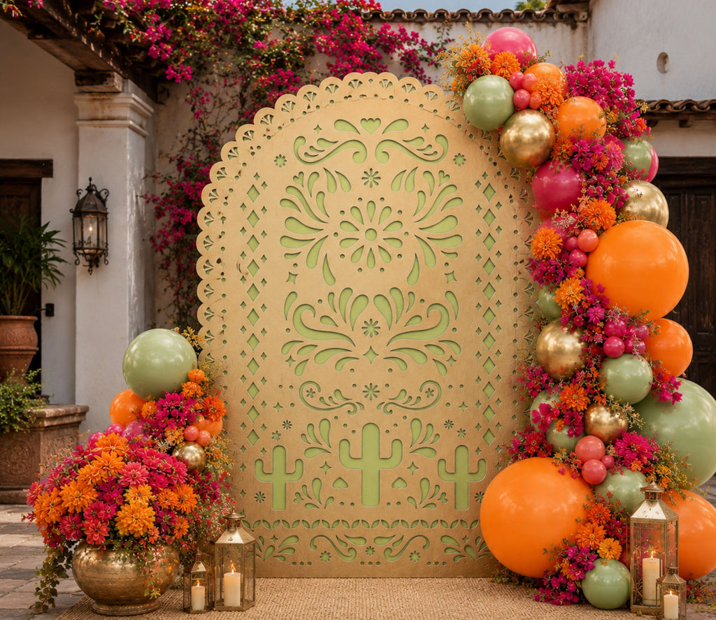 Green papel picado backdrop panel with bright floral and balloon decorations for fiesta event