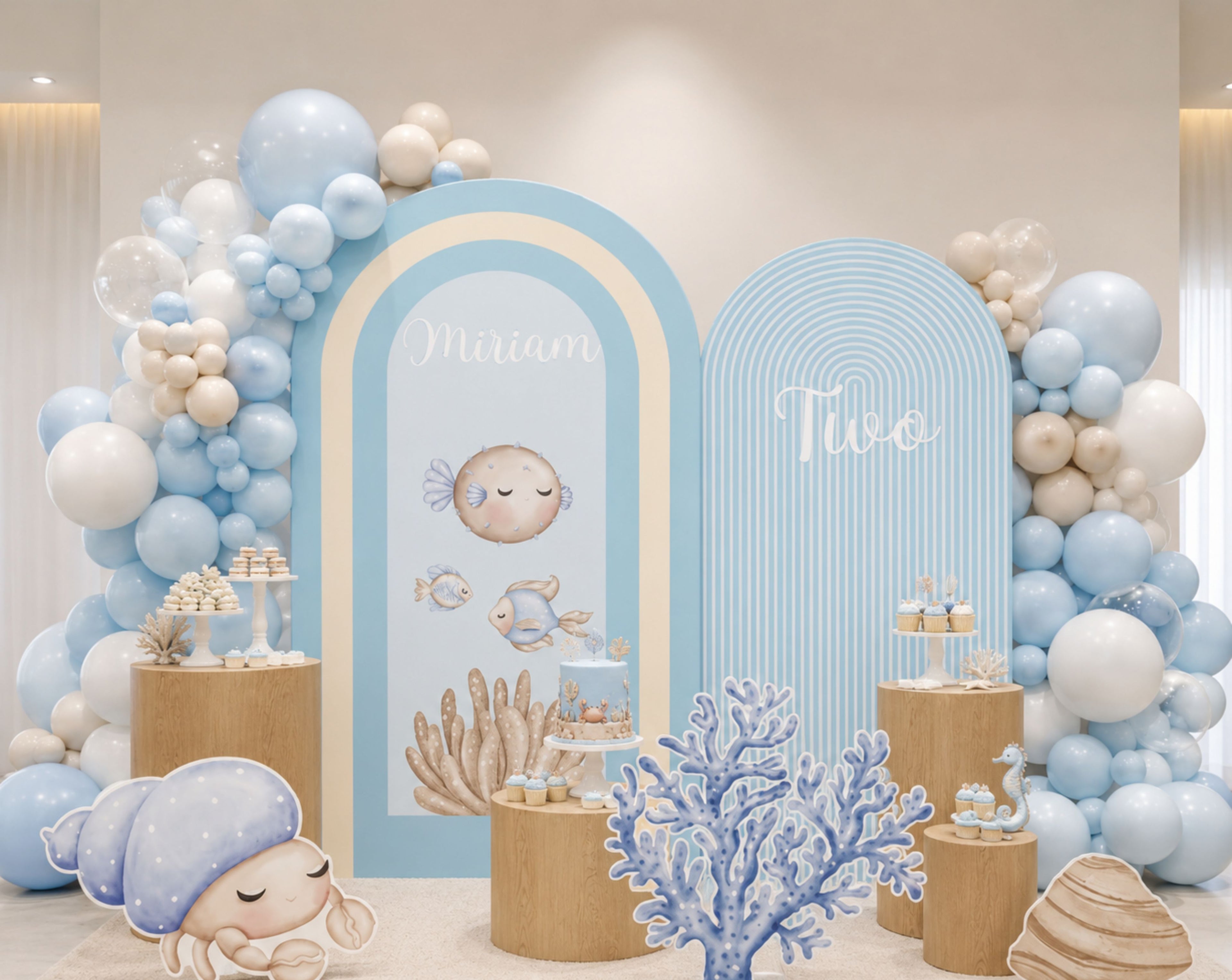 Blue under the sea birthday backdrop with rounded arch panels, balloon clusters and ocean themed cutouts for a personalized kids celebration.